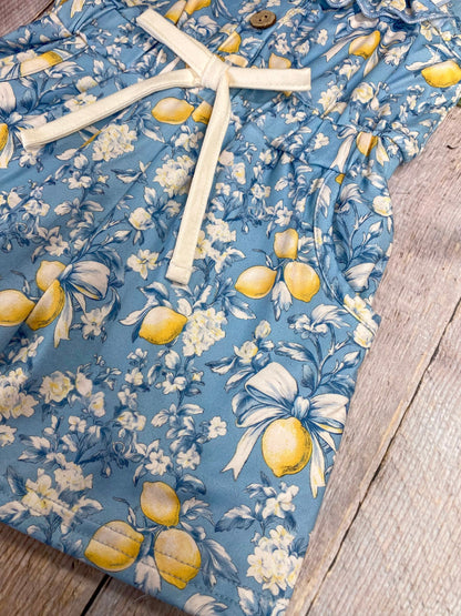 lemon print on romper on wood background