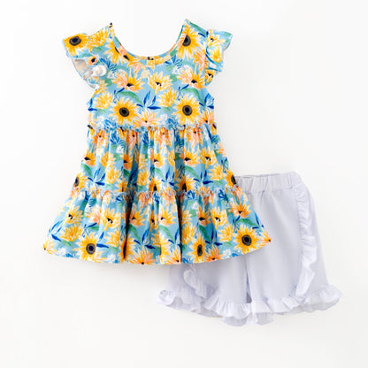 Blue sunflower top and ruffled shorts on white