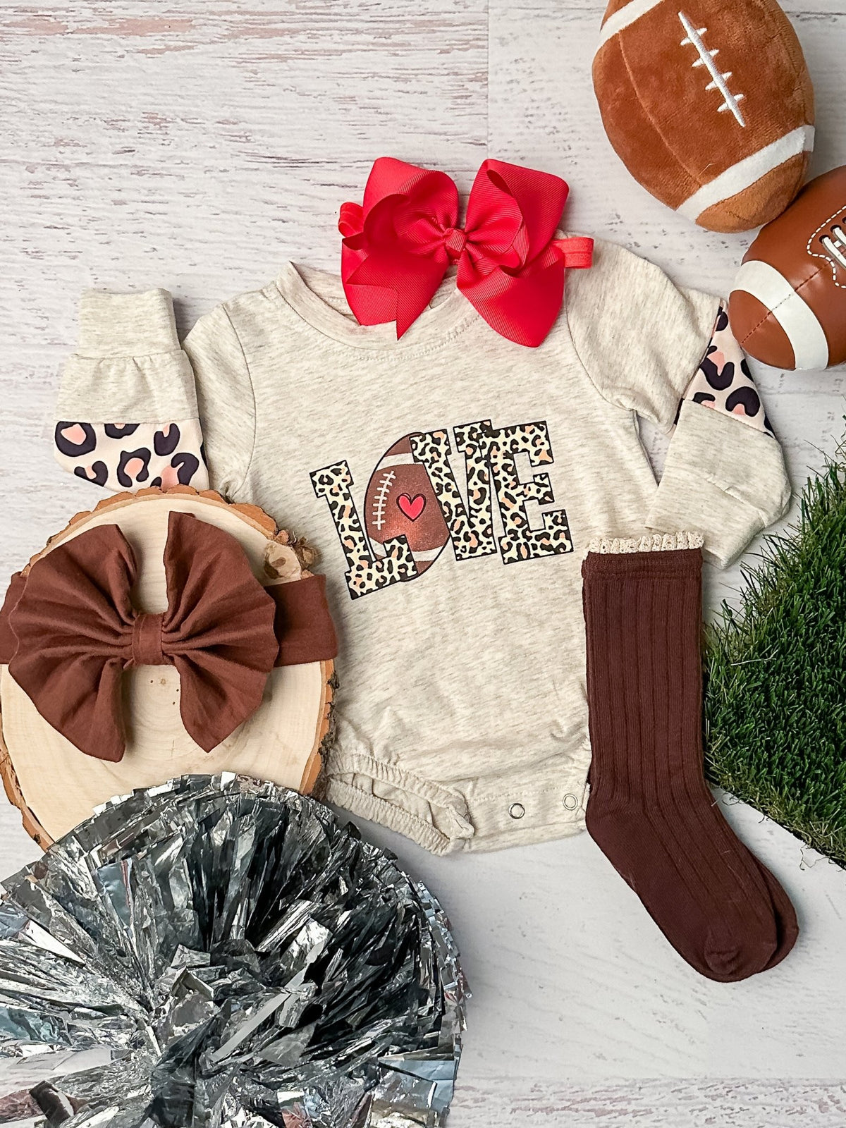 Baby onesie with a football LOVE graphic