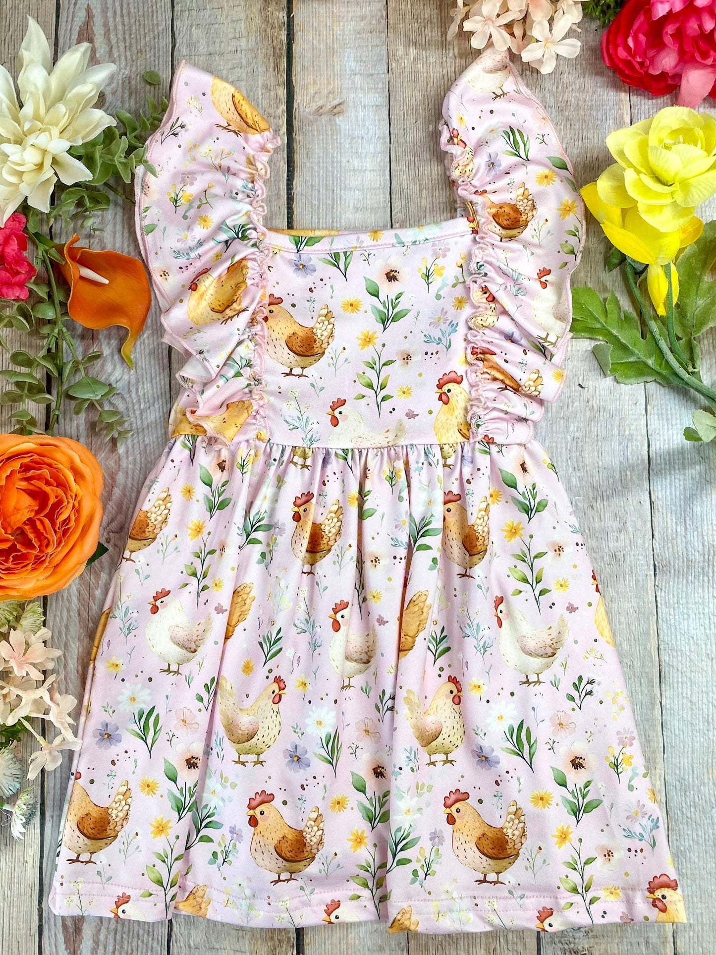 girls hen print dress surrounded by flowers