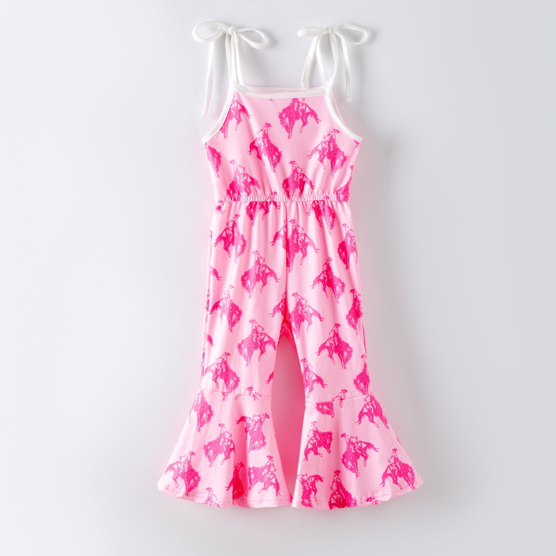 Girls pink rodeo print bell bottom jumpsuit with western cowgirl pattern and tie shoulder straps, boutique girls outfit