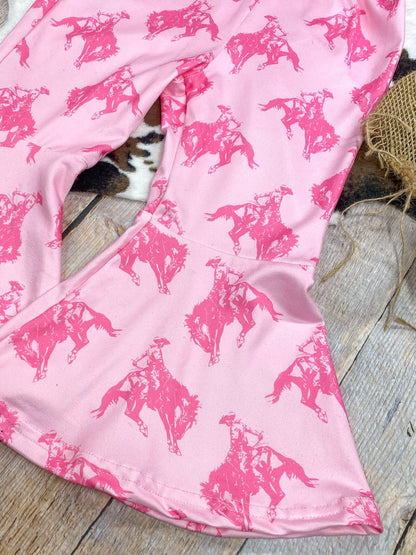 Pink fabric with horse pattern on a wooden surface