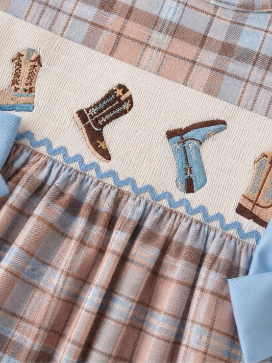 Embroidered cowboy boot smocking on a girls pastel plaid western boutique dress with blue bows. - Alternative view