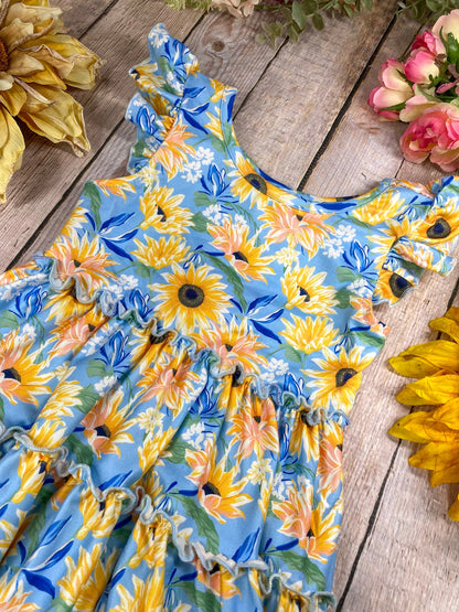 Floral dress with sunflower pattern on a wooden surface
