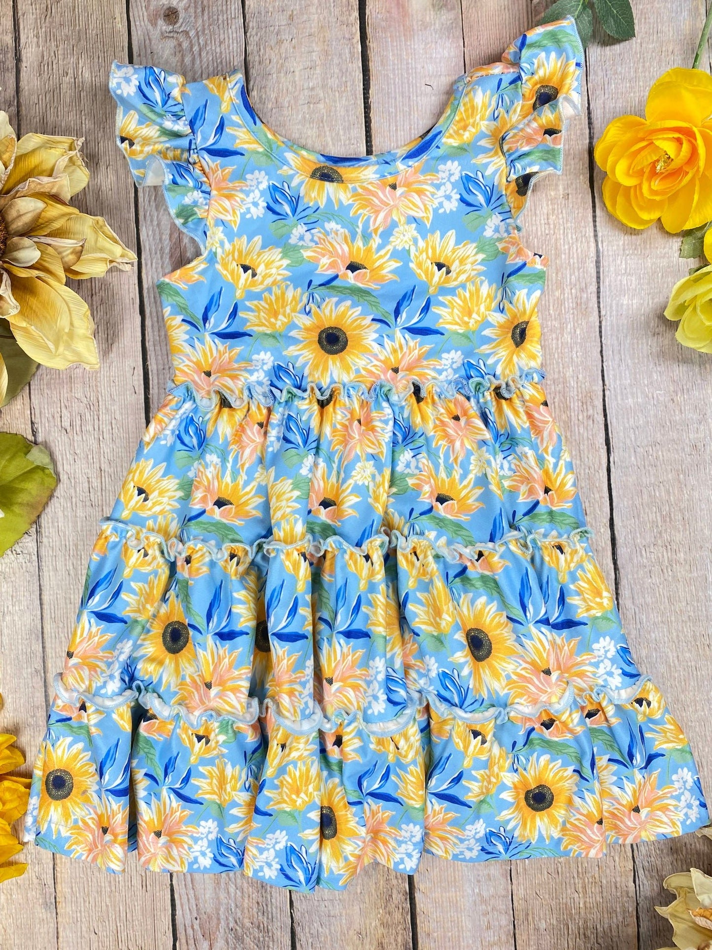 Floral dress with sunflowers on a wooden surface