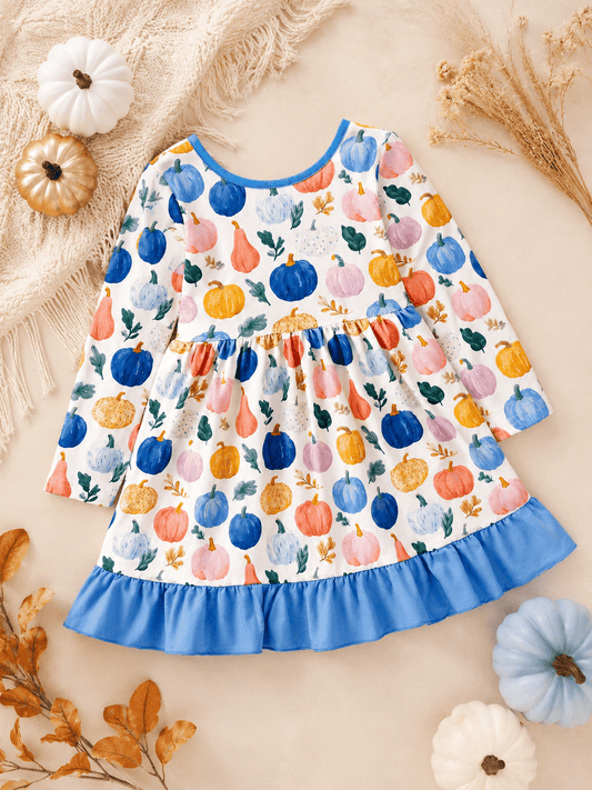 Girls watercolor pumpkin print dress flat lay with blue ruffle hem and boutique fall styling