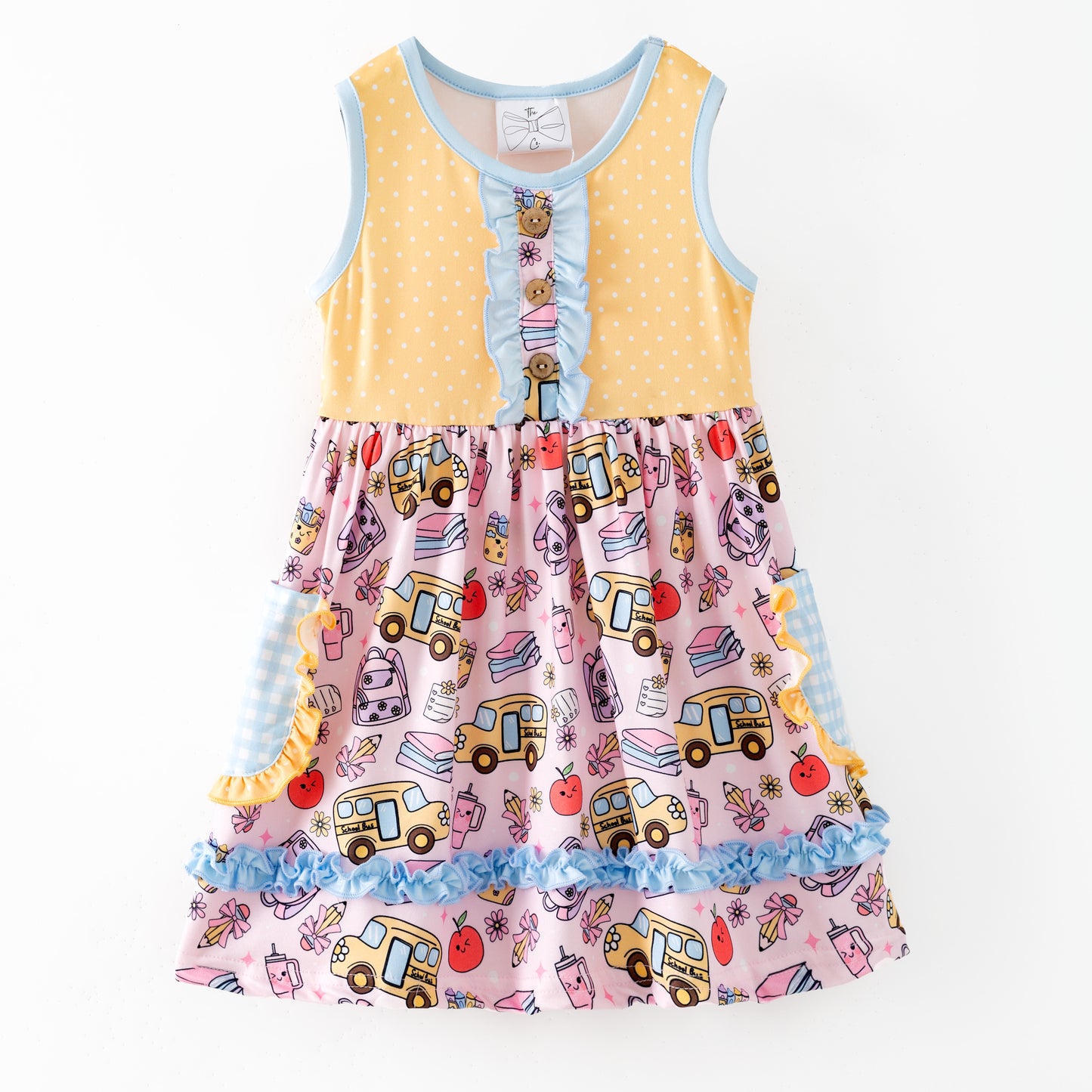Colorful children's dress with cartoon bus and apple pattern on a white background