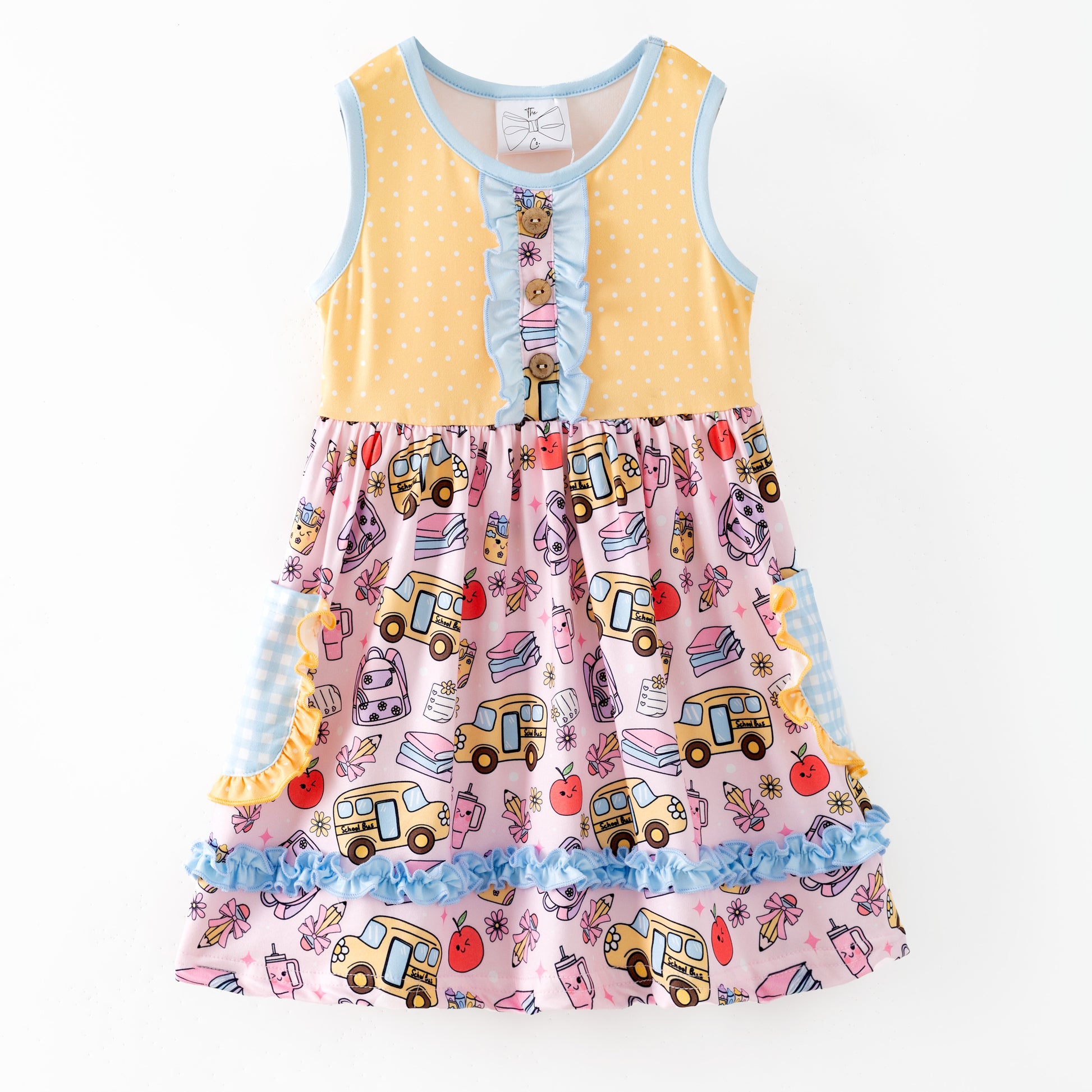 Colorful children's dress with cartoon bus and apple pattern on a white background