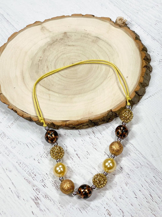 Adjustable rope necklace with gold and animal print beads