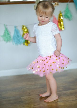 Toddler wearing a light pink gold dot tutu