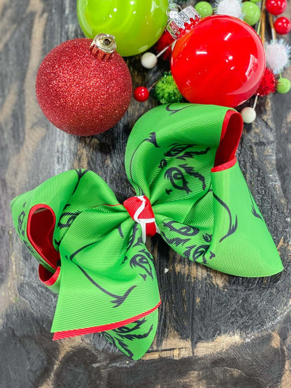 Grinch face double ribbon bow measures approx. 5.5" across and comes on an alligator clip with teeth.
