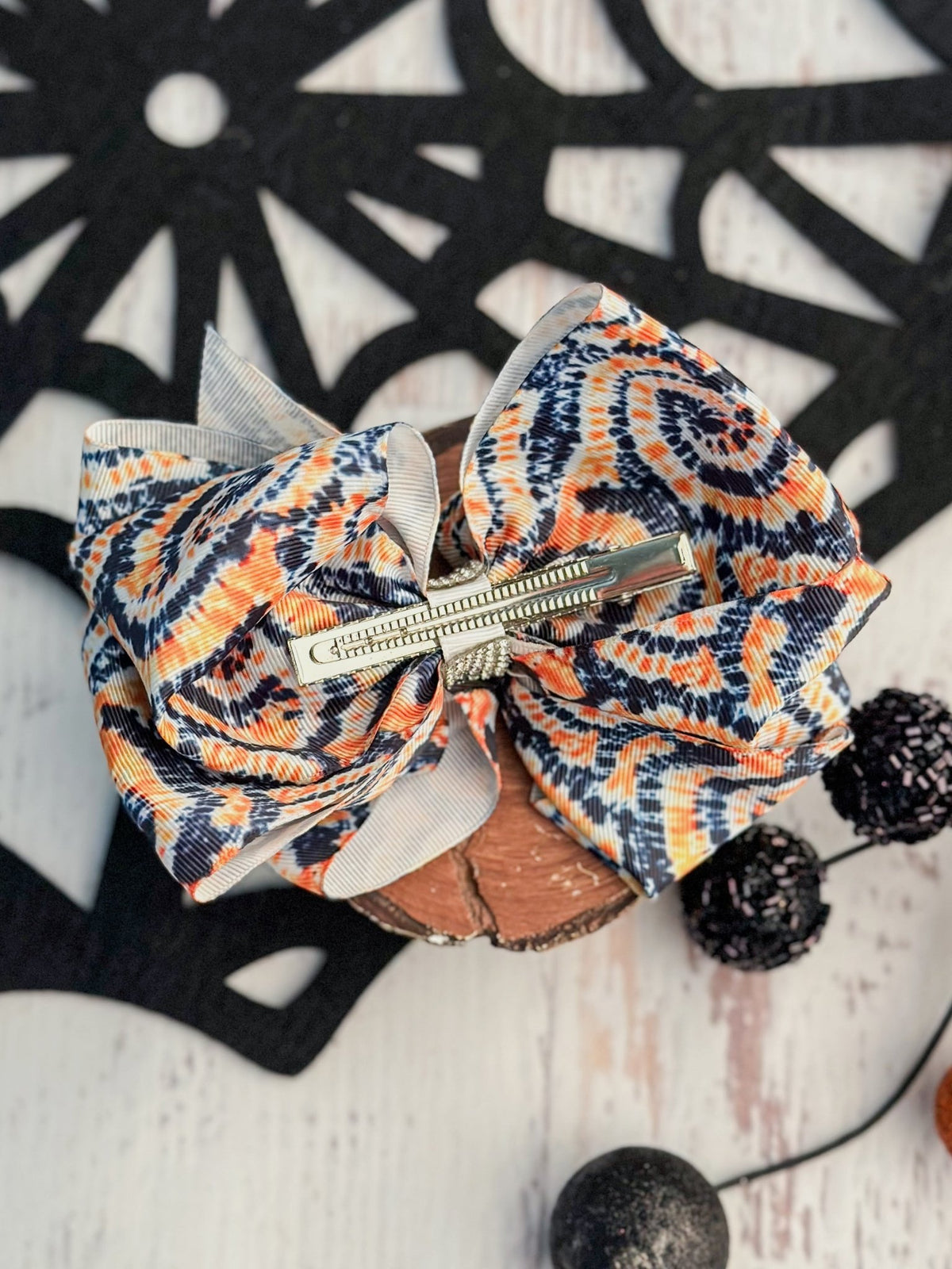Back of Halloween orange and black XL hair bow showing alligator clip