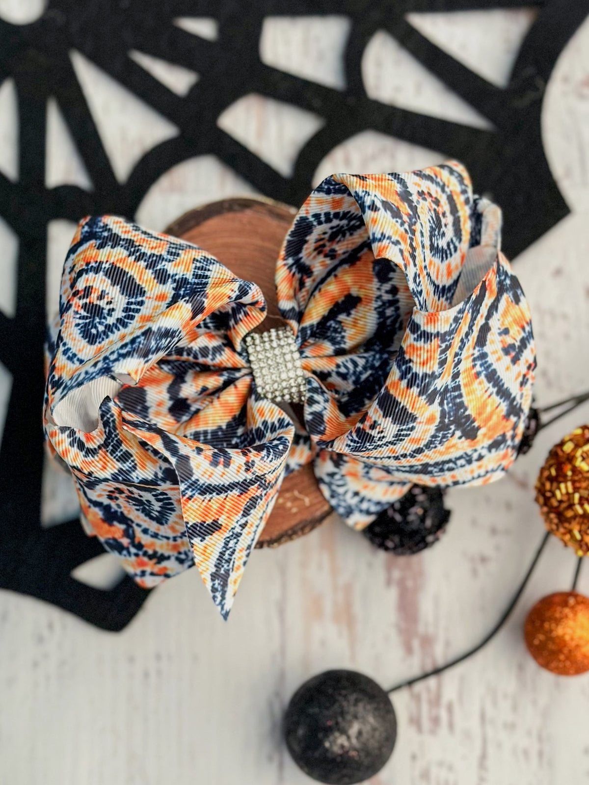 Halloween orange and black tie-dye XL hair bow with rhinestone center