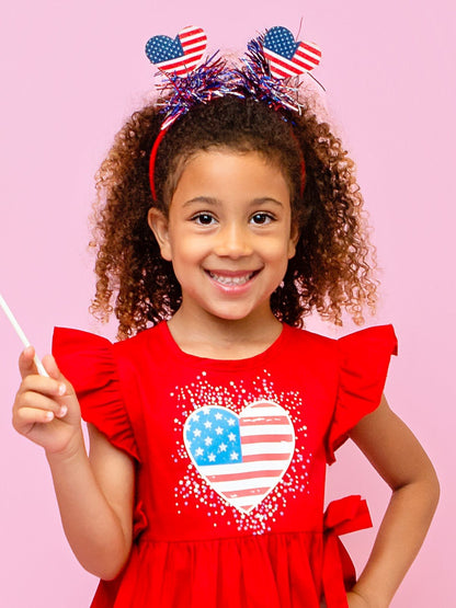 Girl wearing a red, white and blue heart sparkler headband