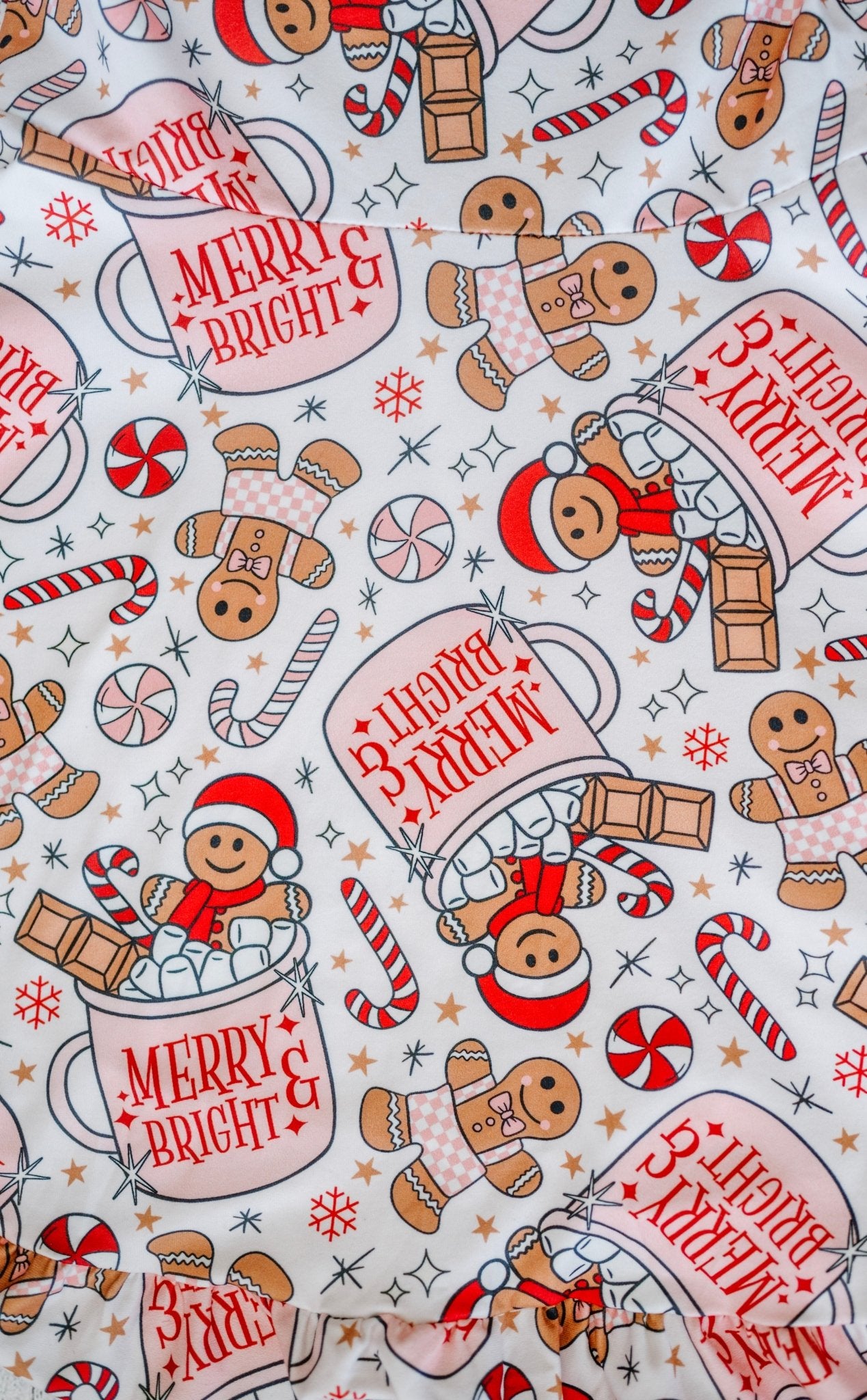 Christmas-themed fabric with gingerbread men, candy canes, and 'Merry & Bright' text 