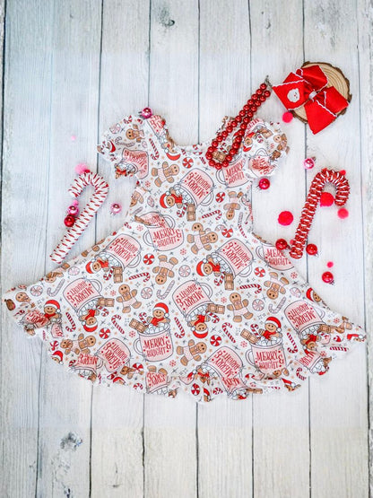 Christmas-themed apron with gingerbread design on a wooden surface