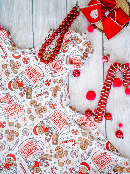 Christmas-themed fabric with gingerbread men, candy canes, and 'Merry & Bright' text on a wooden surface.