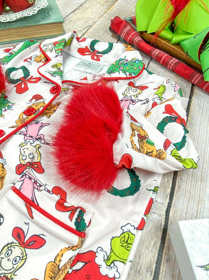 Close-up of red faux fur cuffs and buttons on Grinch pajamas