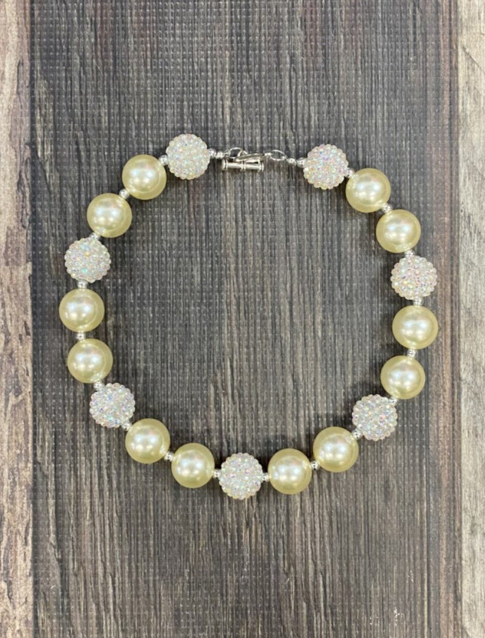 Ivory chunky bead necklace with a heart toggle closure.