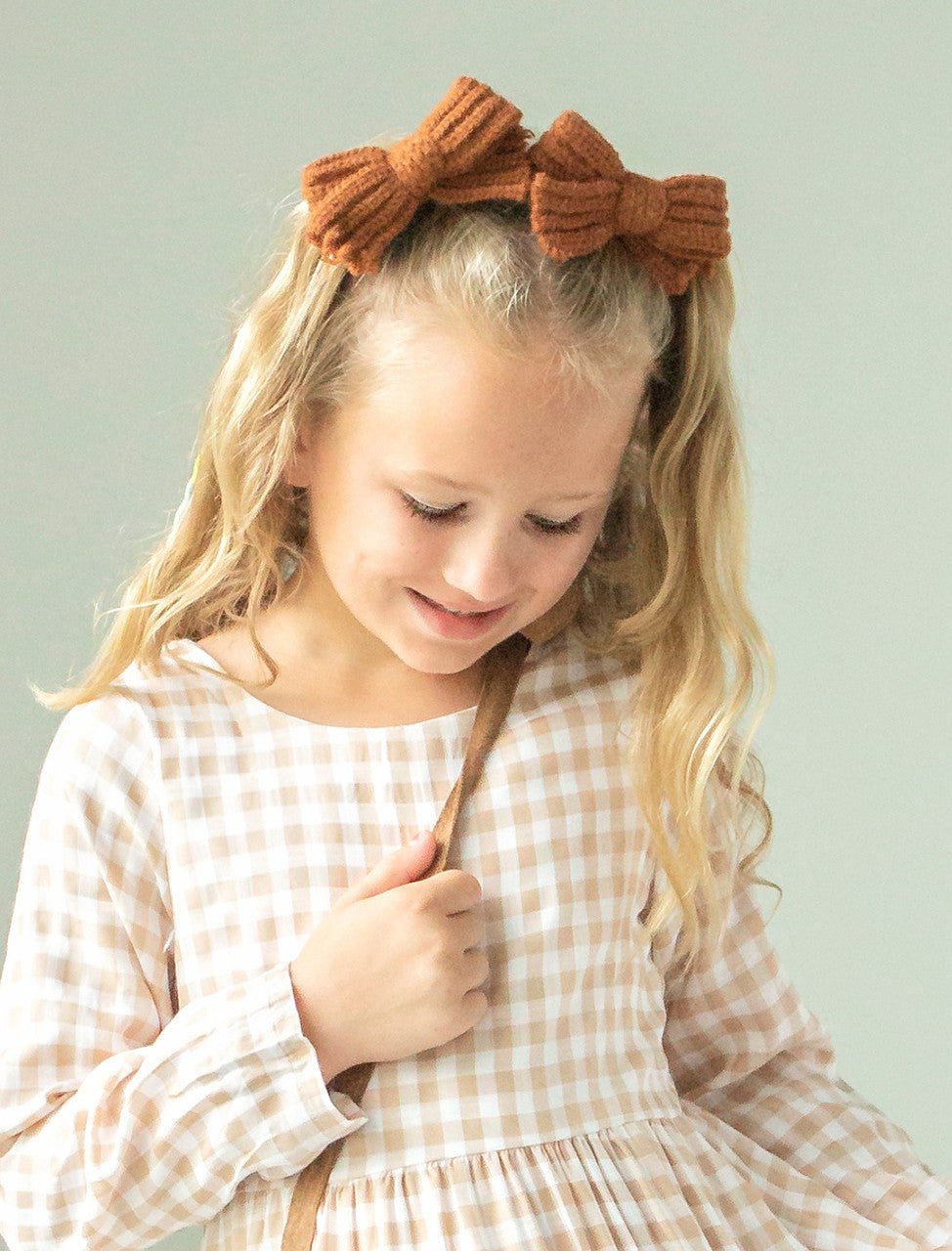 Knitted Hair bow on model in a set of 2, these are sold INDIVIDUALLY.