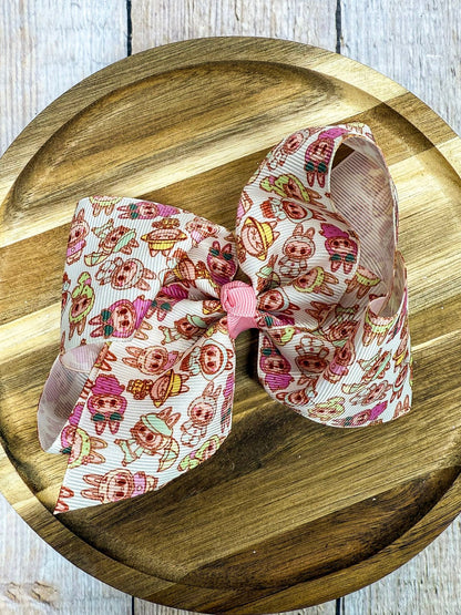 Decorative bow with cartoon labubu character pattern on a wooden surface
