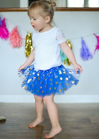 toddler wearing blue gold dot tutu 
