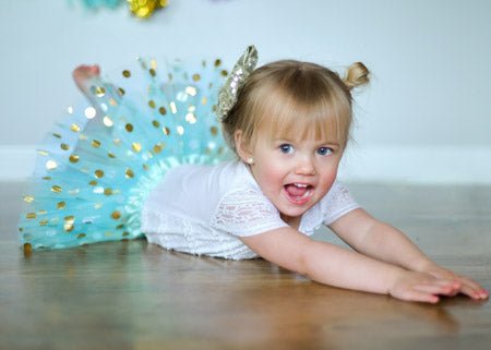 toddler wearing aqua gold dot tutu