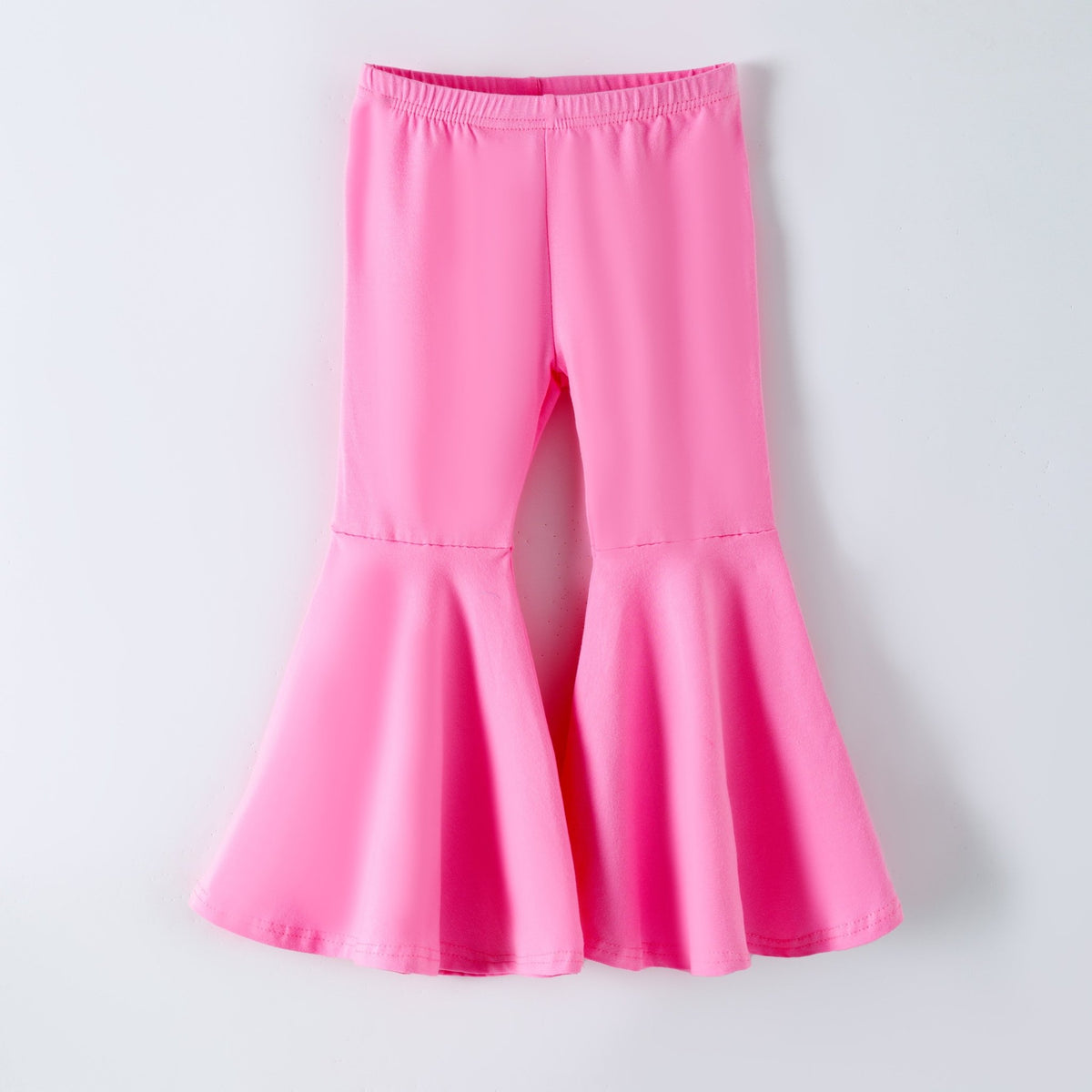 Light pink bell bottoms laid flat