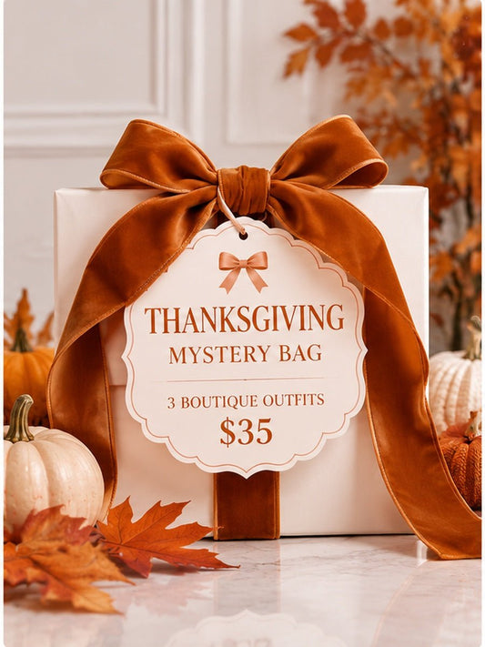 Pink and cream Thanksgiving Mystery Bag gift box with velvet bow, pumpkins and fall leaves, featuring 3 girls boutique outfits for $35.