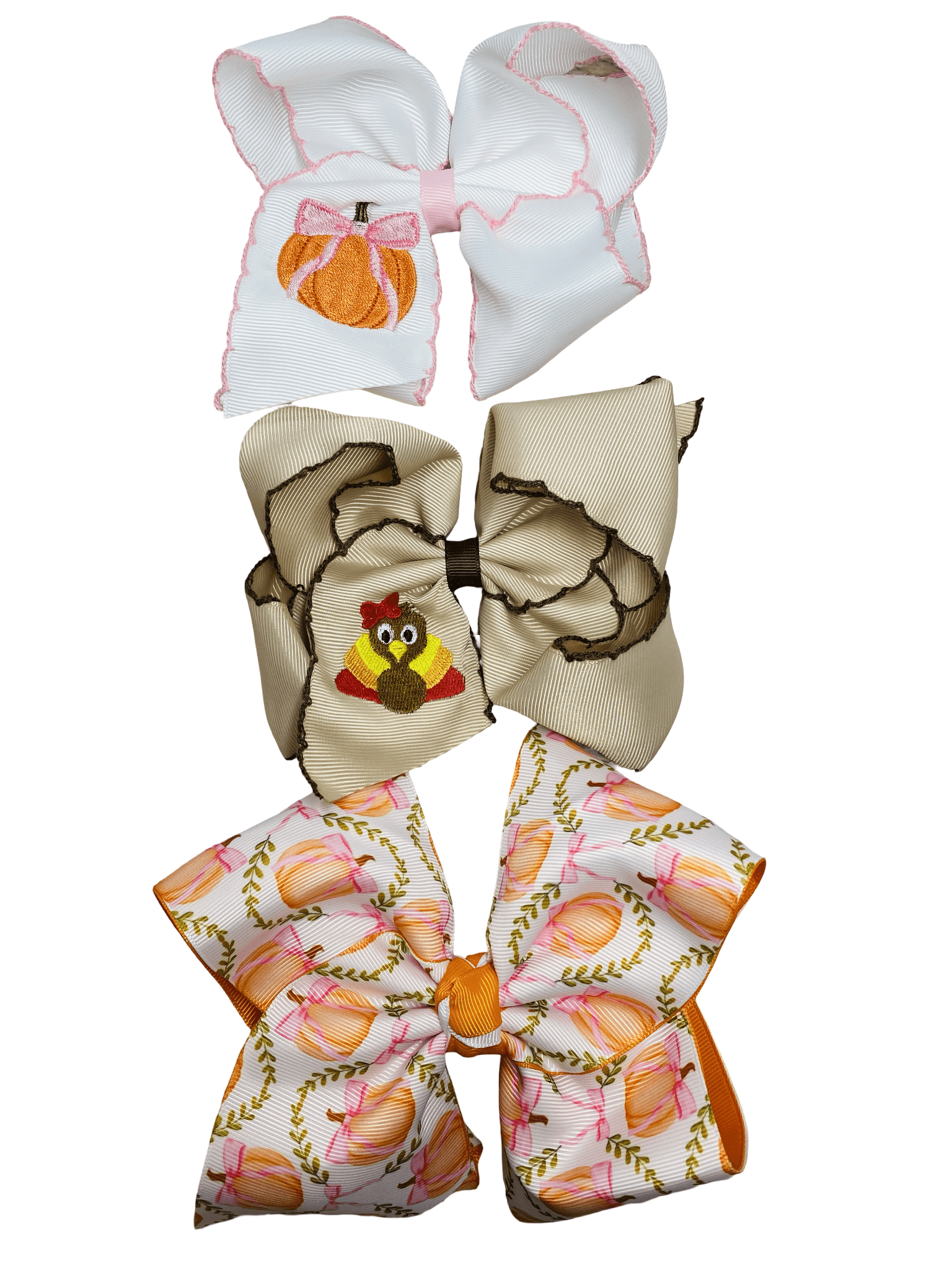 Three decorative bows with different fall patterns on a white background
