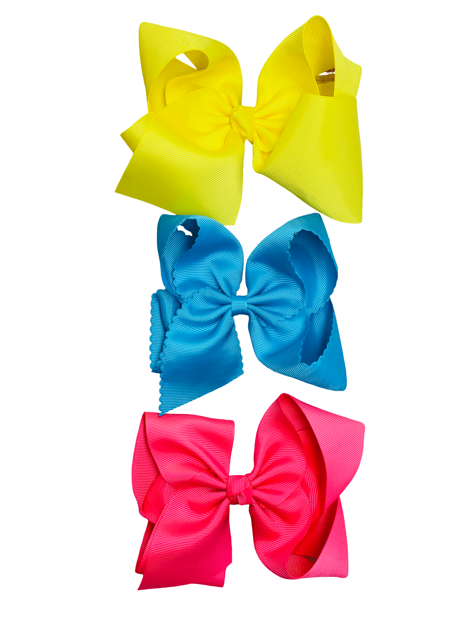 Three colorful hair bows (yellow, blue, pink) on a white background