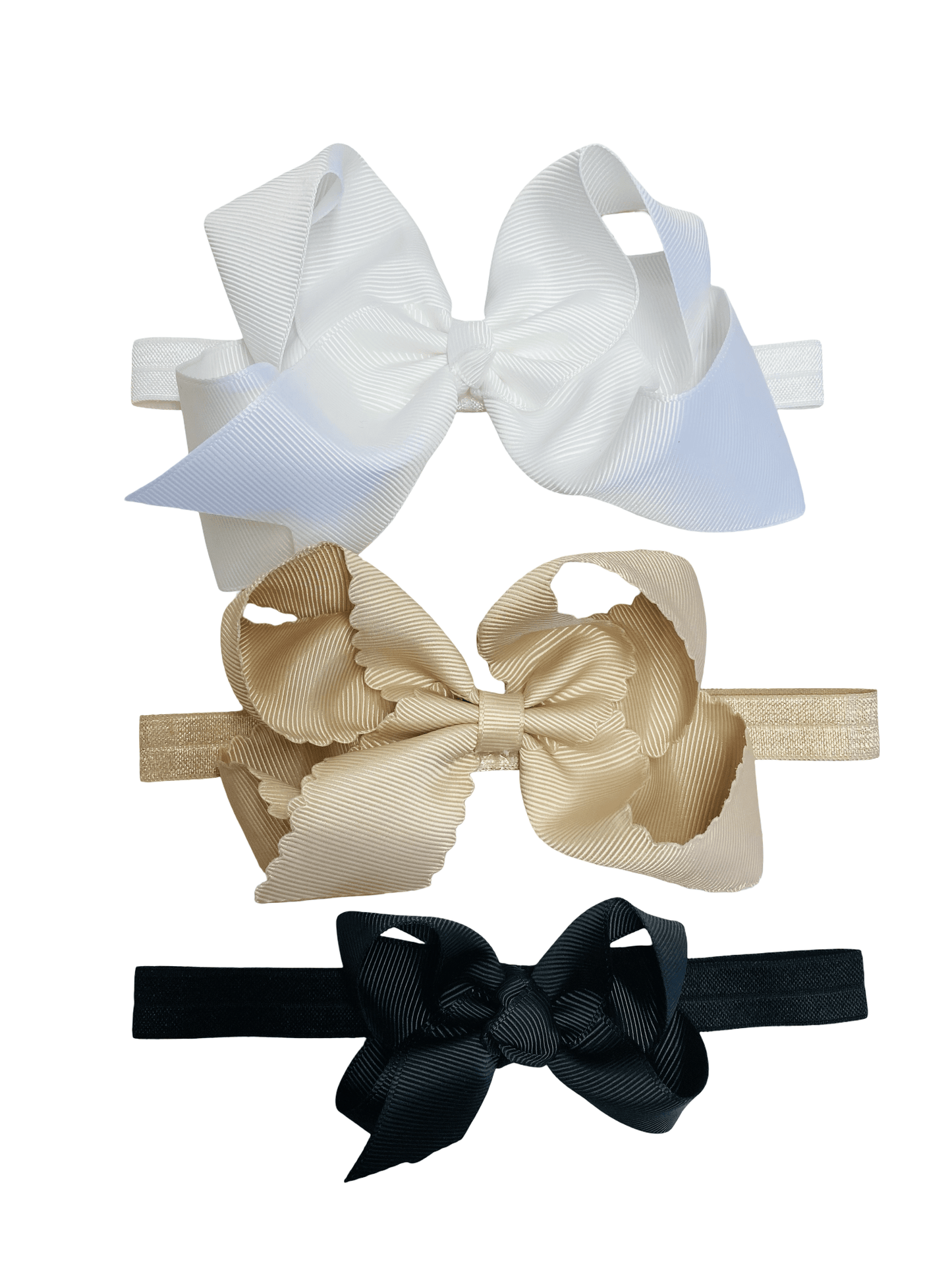 Three hair bows in white, beige, and black on a white background