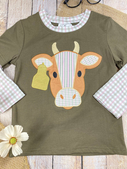 boys western long sleeve top with cow appliqué and faux gingham layered sleeve accents on a wooden background