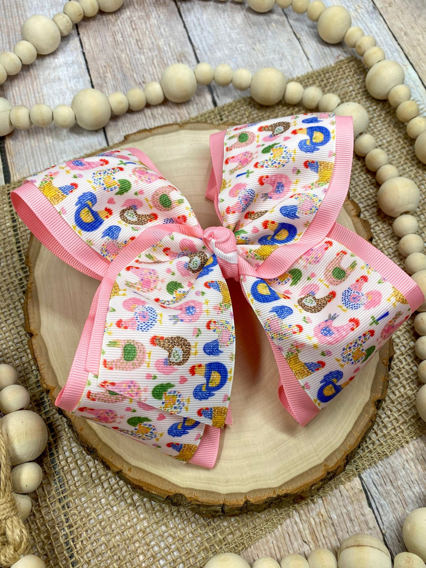 Little Chicken Patch Print Double Layer Hair Bow on a wooden surface