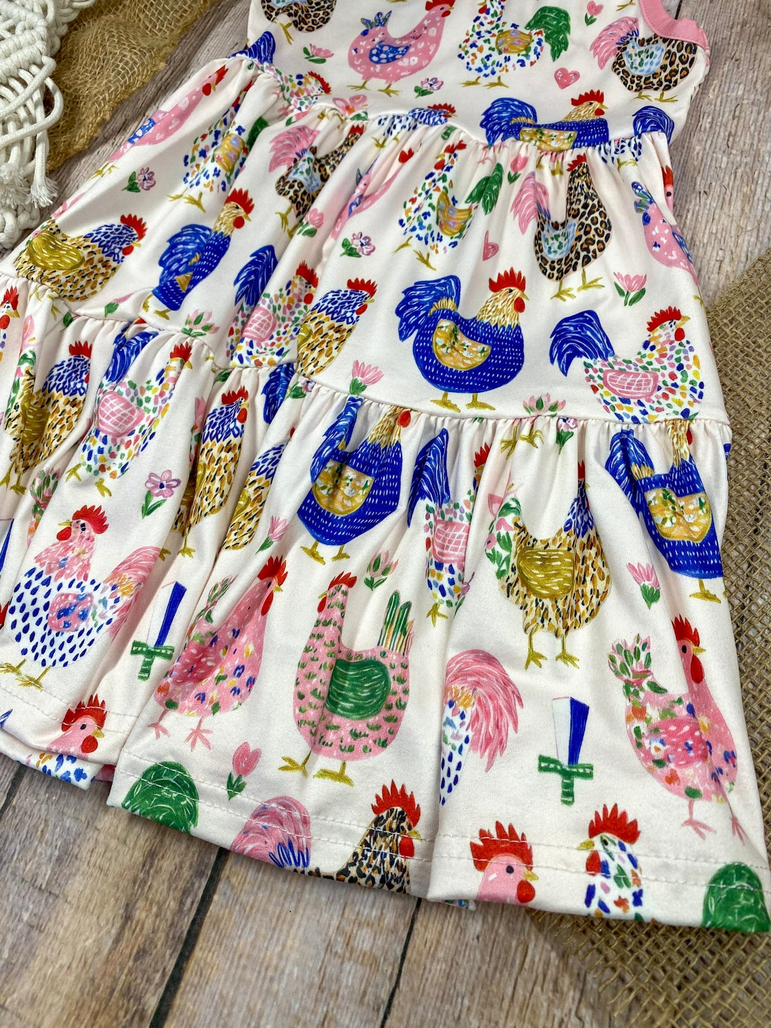 Girls Boutique dress with chicken pattern on a light wooden background