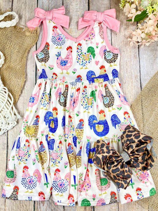 Girls Boutique dress with chicken pattern on a light wooden background