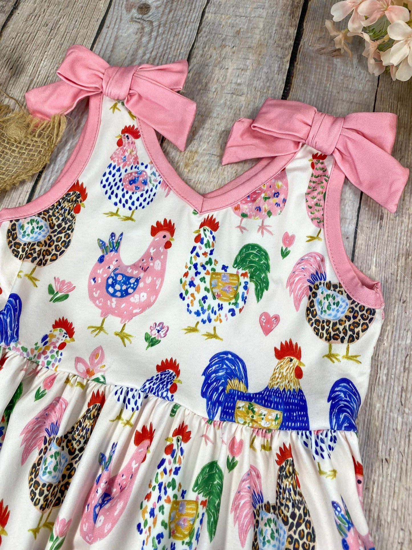 Girls Boutique dress with chicken pattern on a light wooden background