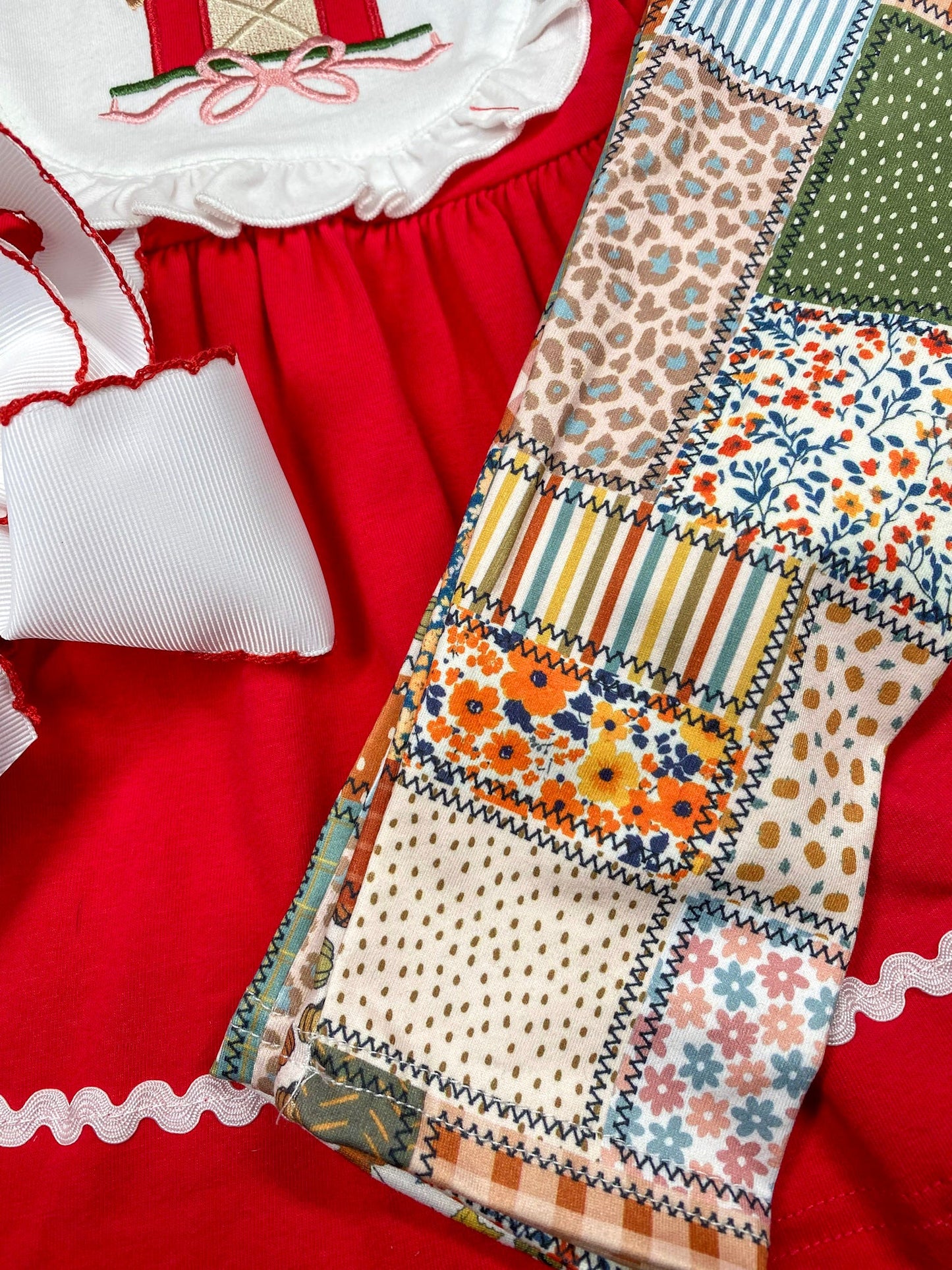 girls fall two-piece with red barn appliqué ruffle bib top and patchwork print leggings