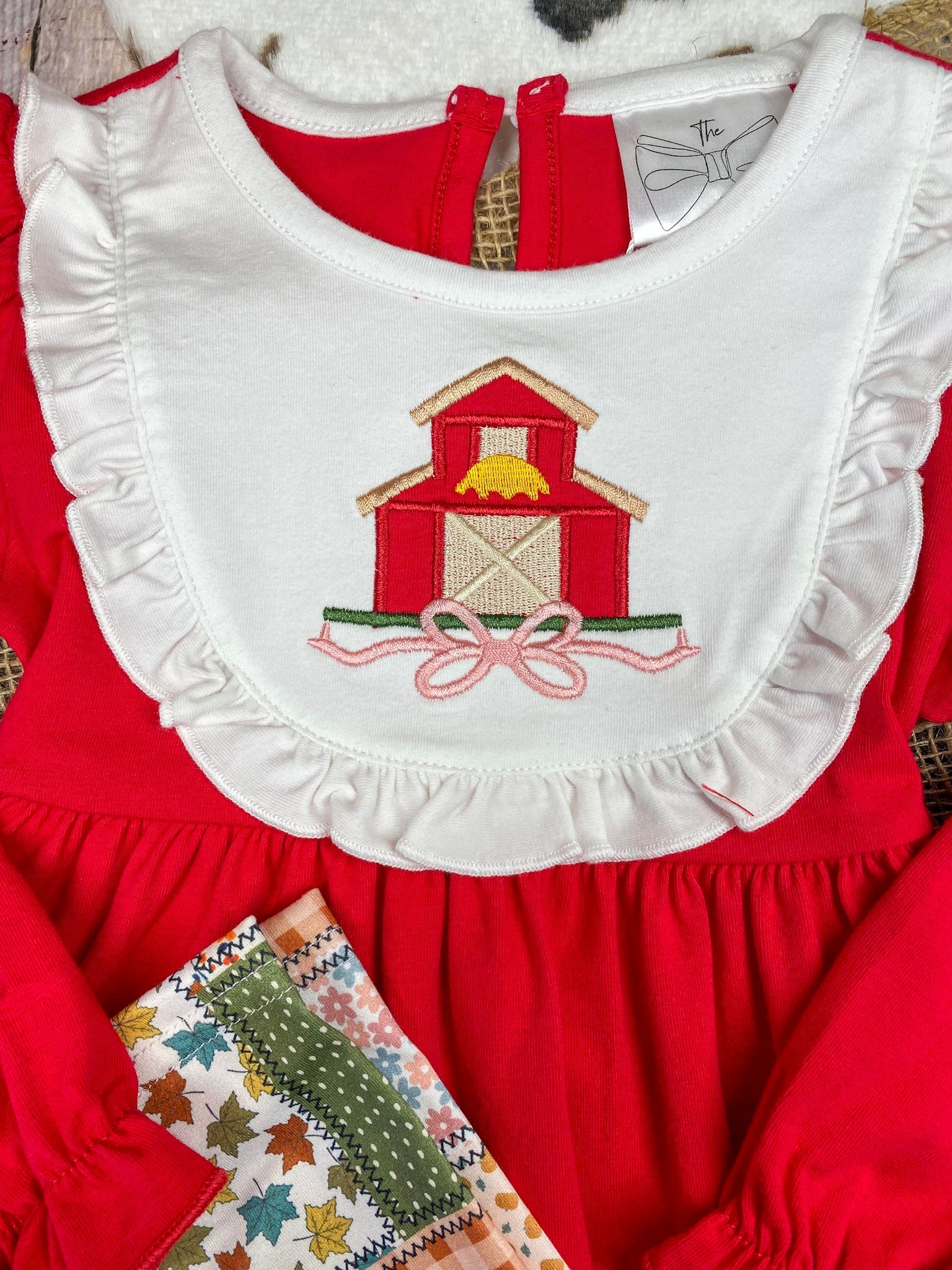 girls fall two-piece with red barn appliqué ruffle bib top and patchwork print leggings