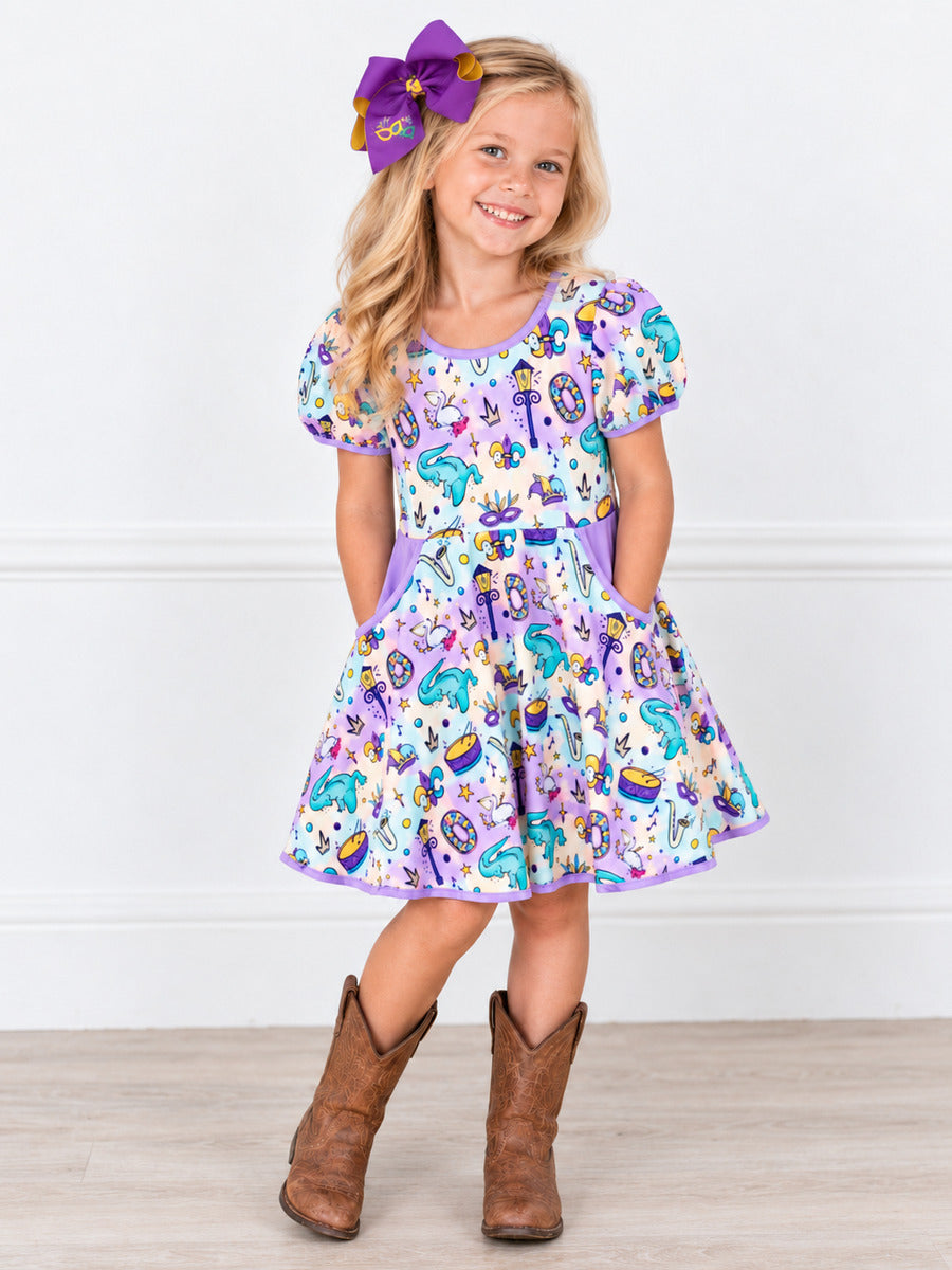 mardi grad dress on model in front of white wall. 