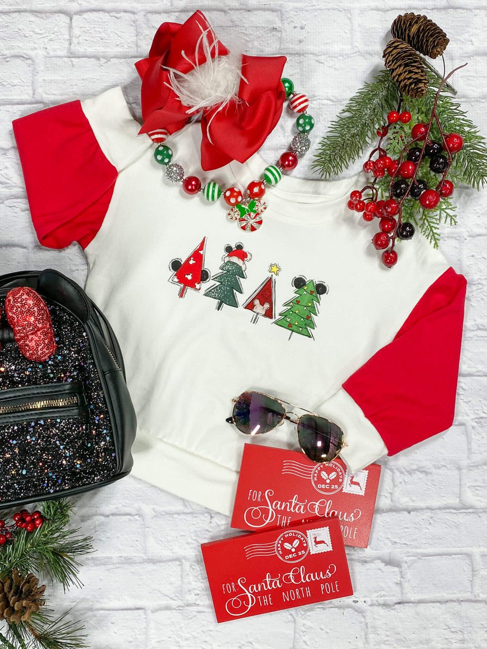 Long sleeve top with a white bodice and red sleeves with a Christmas tree design