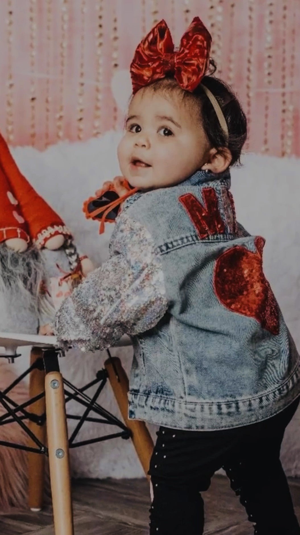 Girl wearing the denim jacket with a big red bow