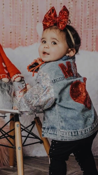 Girl wearing the denim jacket with a big red bow