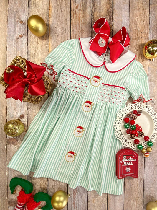 Mint striped girls Christmas dress with embroidered Santas, smocked detail, and Peter Pan collar – perfect holiday outfit.