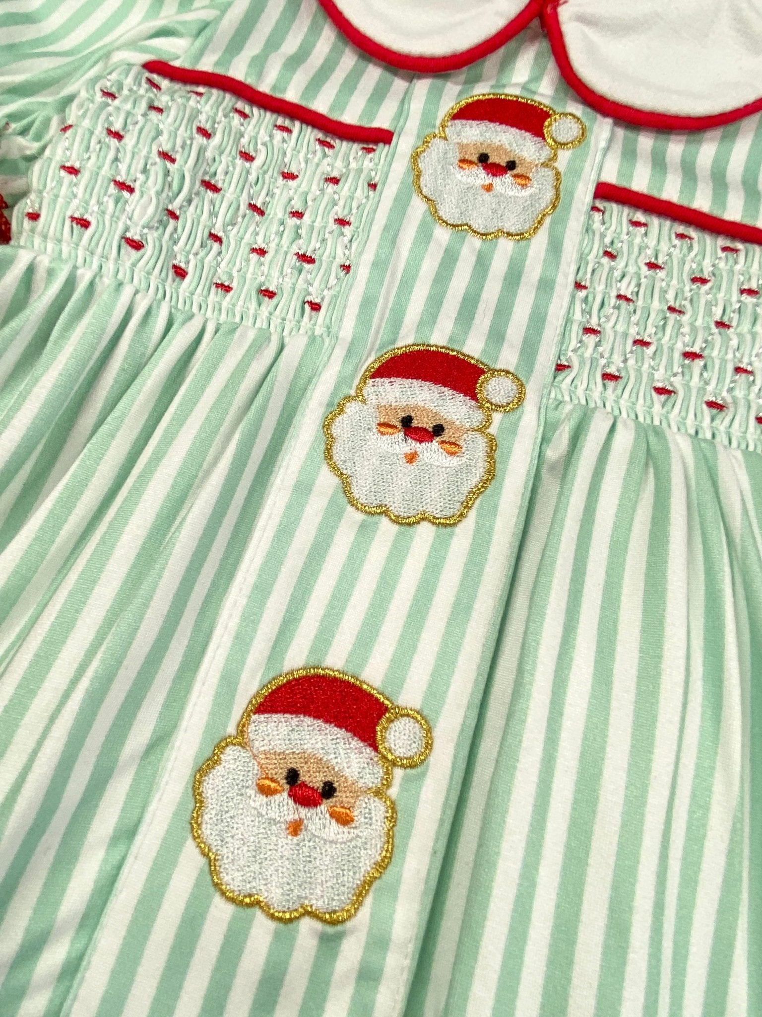 Green and white striped dress with embroidered Santa Claus faces