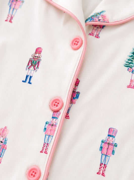 Close-up of Pink Nutcracker Christmas pajamas with pastel nutcracker print, pink piping, and button-front detail. - Alternative view