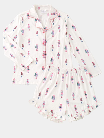 Women's Pink Nutcracker Christmas pajama set with pastel nutcracker print, button-front top, and ruffle shorts.
