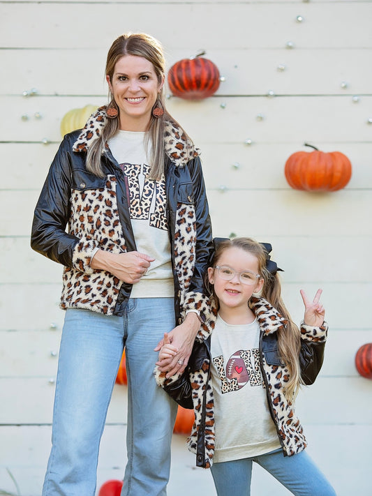 Mom and daughter in matching black animal print coats