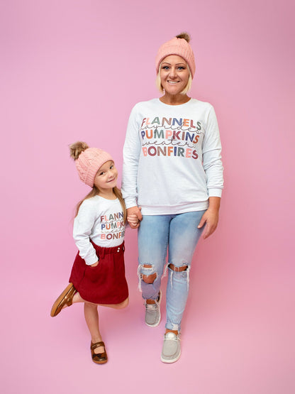 Mom and daughter wearing the flannels and bonfires shirts