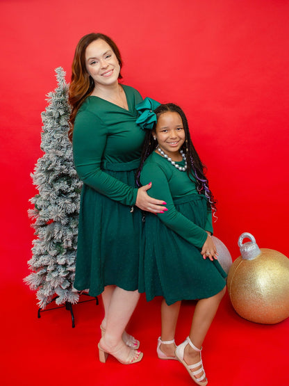 Mom and daughter in matching green swiss dot Christmas dresses